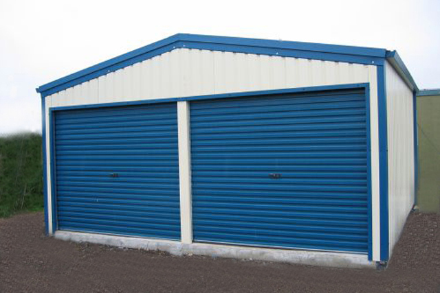 A white building with blue roller doors